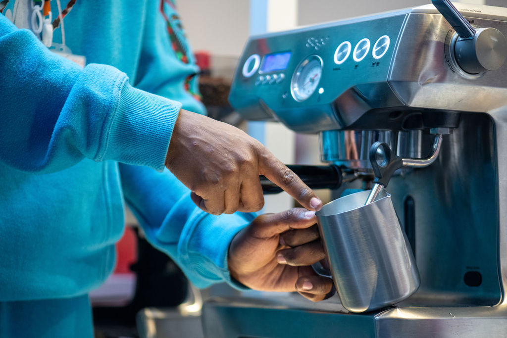 A close up of Antony from Kwetu Coffee making coffee during one of his workshops