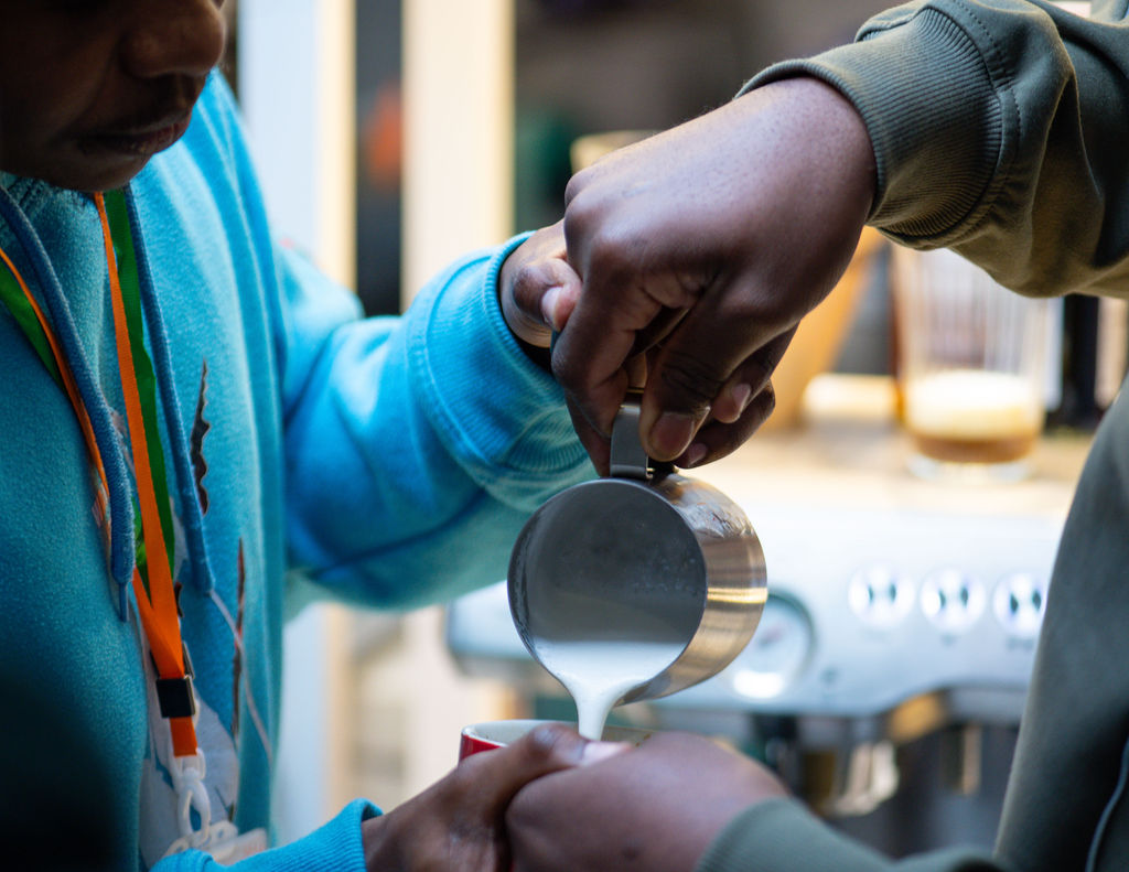 Image of Antony teaching someone barista skills