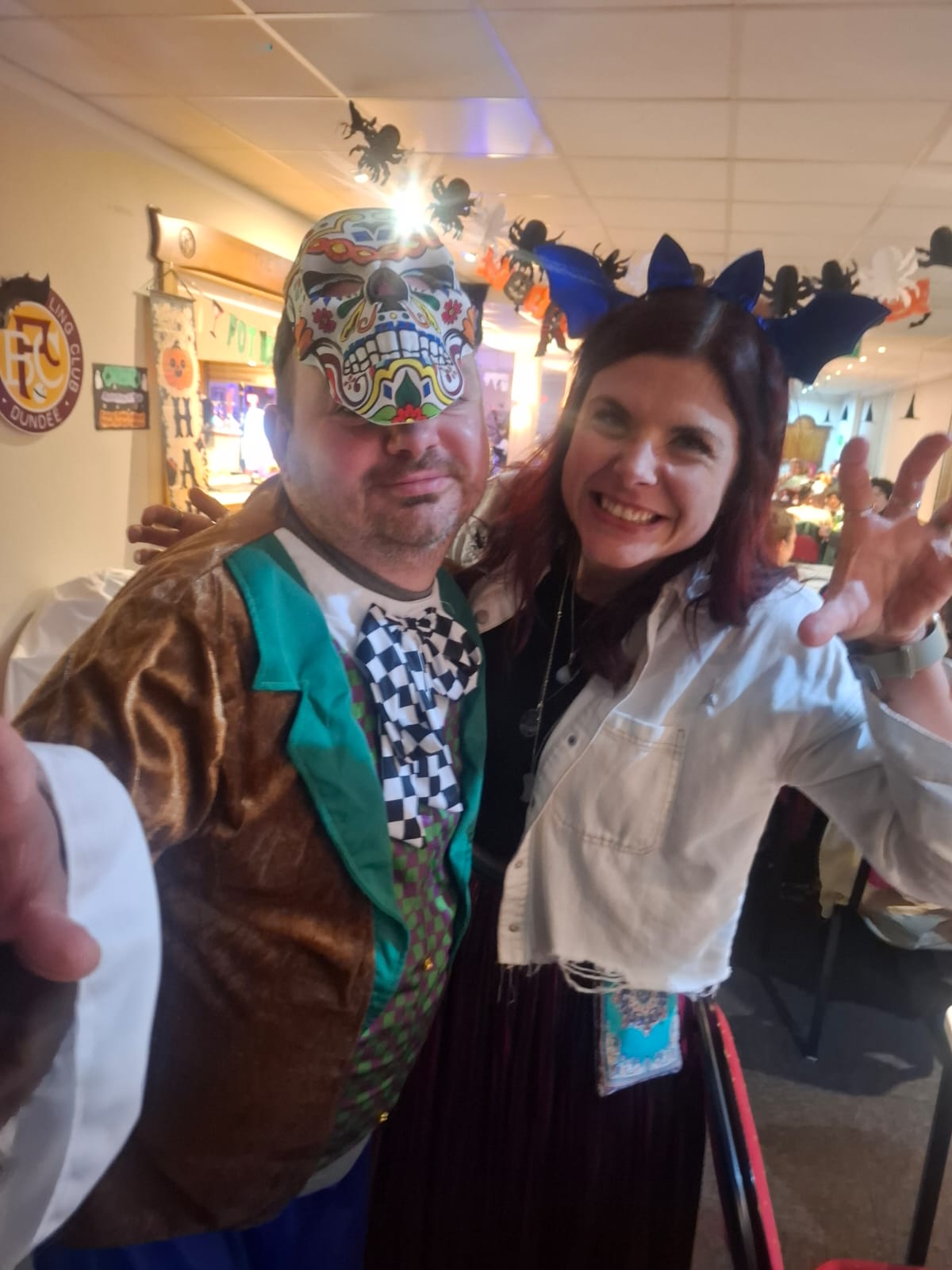 Image of two people in costumes at an Uppertunity event smiling at the camera