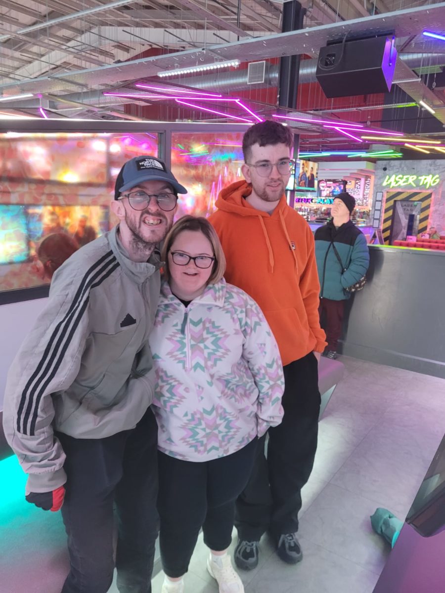 Three people at an Uppertunity day out smiling and looking at the camera